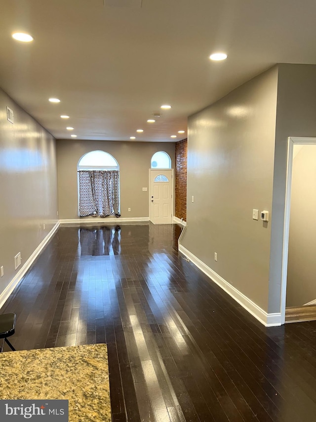 interior space featuring recessed lighting, baseboards, and hardwood / wood-style flooring