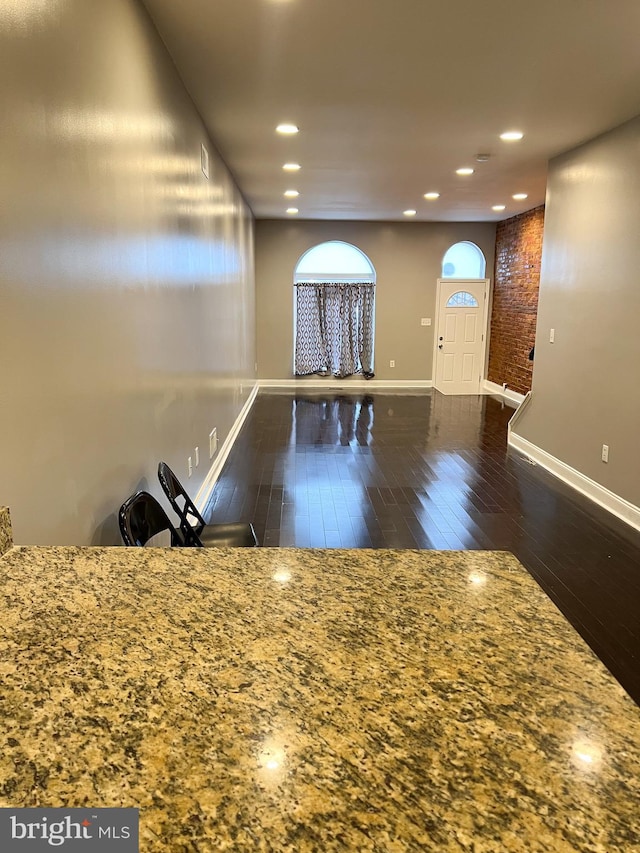 interior space with recessed lighting, baseboards, and wood finished floors