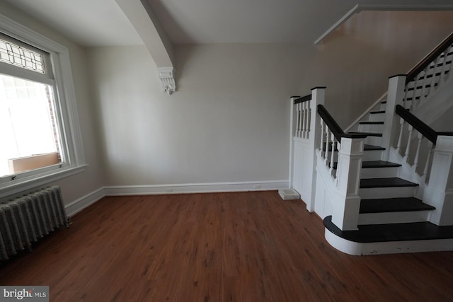 staircase with radiator and wood-type flooring