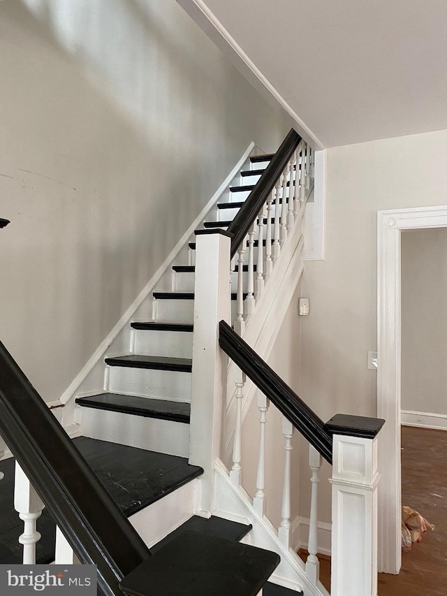 stairs featuring wood-type flooring