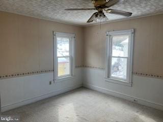 spare room featuring ceiling fan, ornamental molding, and a textured ceiling