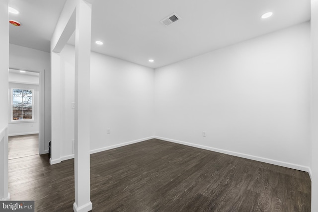 unfurnished room with dark hardwood / wood-style flooring