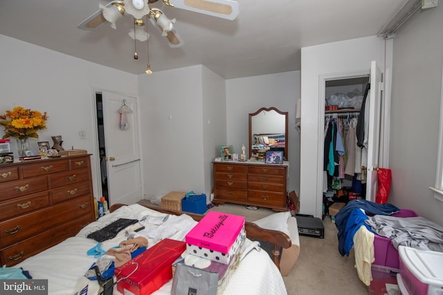 carpeted bedroom with ceiling fan, a spacious closet, and a closet