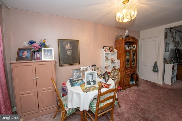 dining area featuring carpet floors and a chandelier