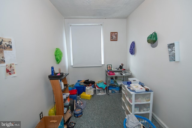 game room featuring carpet floors and a textured ceiling