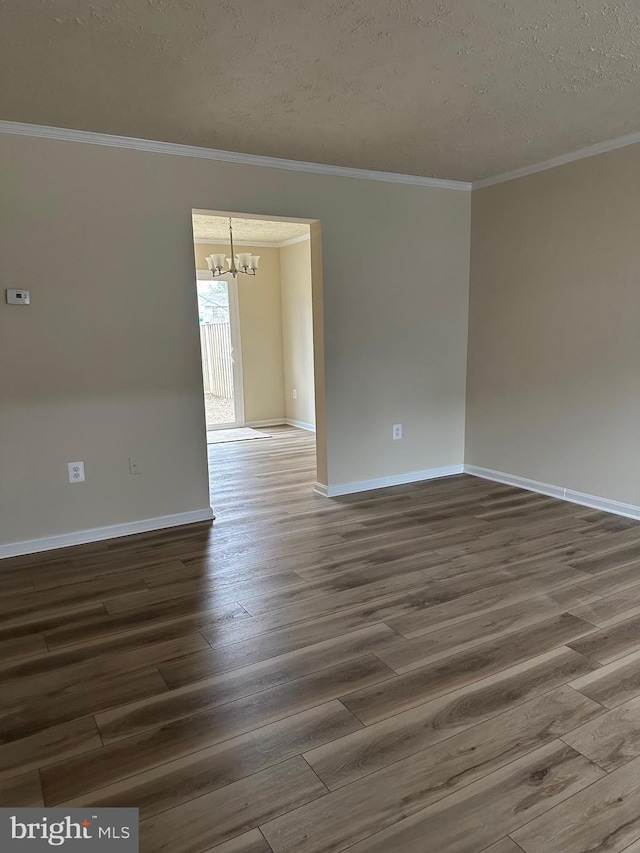 empty room featuring crown molding, dark hardwood / wood-style floors, and a textured ceiling