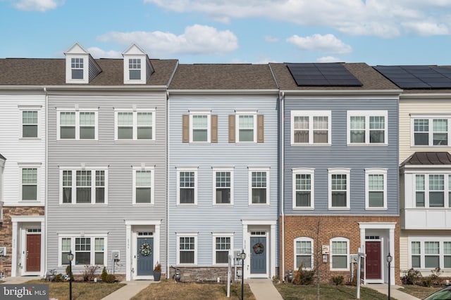 townhome / multi-family property featuring solar panels