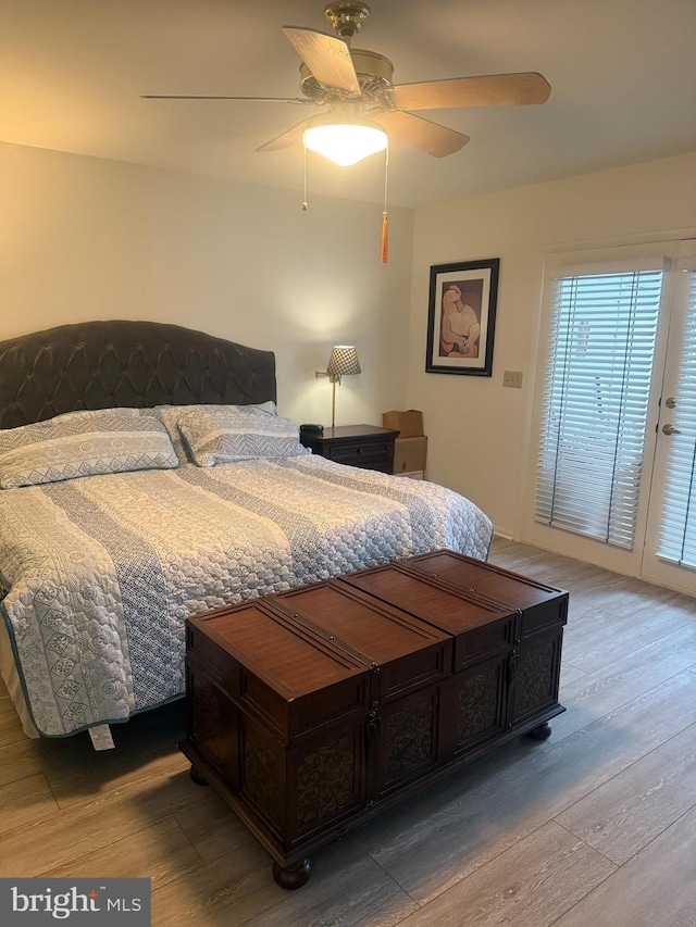 bedroom featuring hardwood / wood-style floors, ceiling fan, and access to exterior