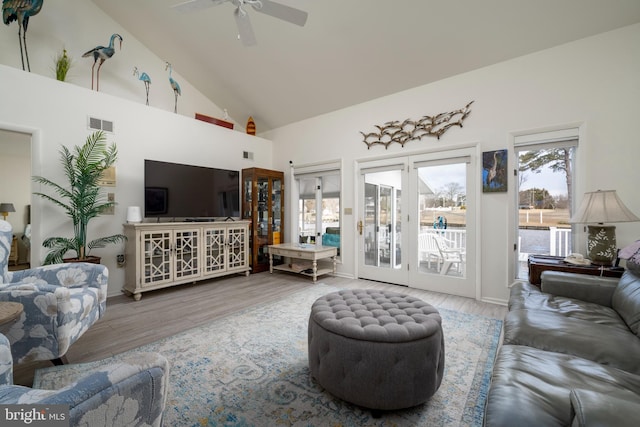 living room featuring ceiling fan, a wealth of natural light, high vaulted ceiling, and wood-type flooring