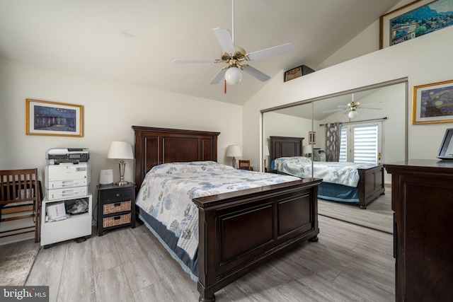 bedroom with ceiling fan, lofted ceiling, a closet, and light wood-type flooring