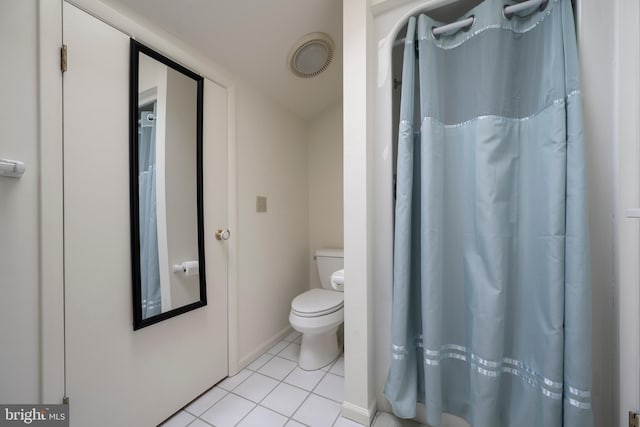 bathroom with toilet and tile patterned flooring