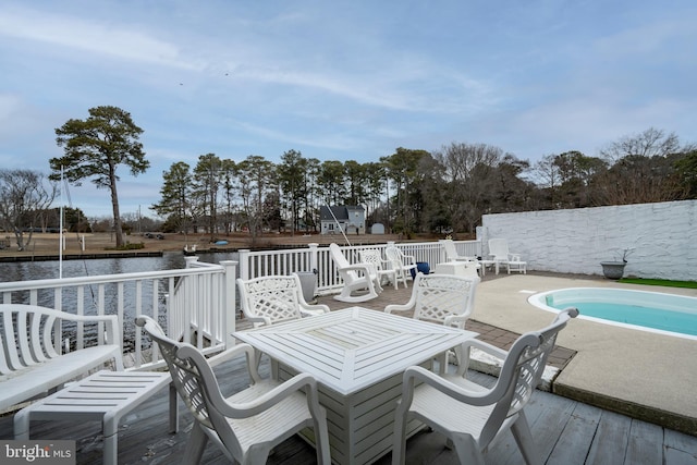 view of patio with a pool side deck with water view