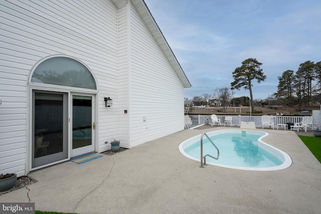 view of swimming pool with a patio area