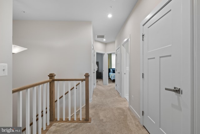 corridor with light colored carpet