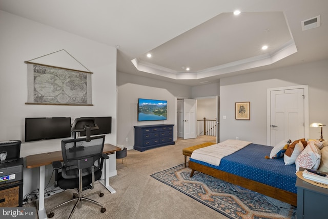 bedroom featuring ornamental molding, light carpet, and a tray ceiling