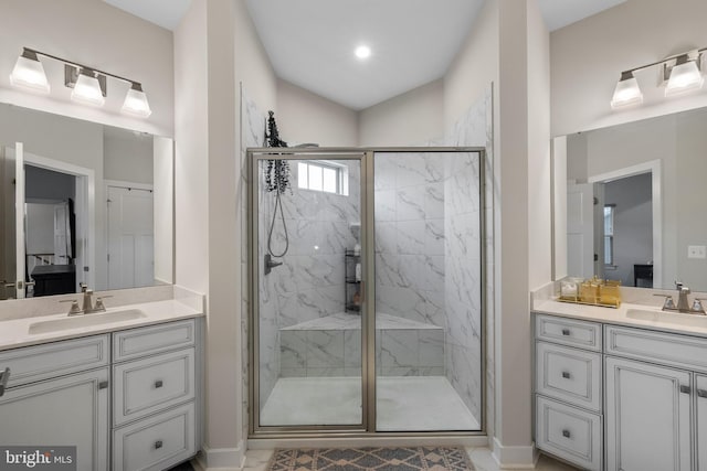 bathroom with an enclosed shower, vanity, and lofted ceiling