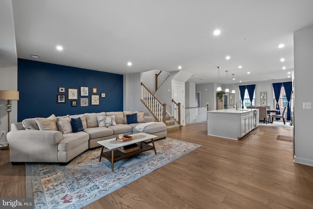 living room featuring sink and light wood-type flooring