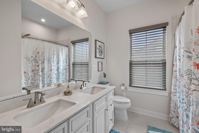 bathroom with vanity, tile patterned floors, and toilet