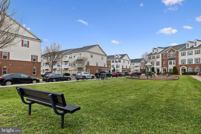 surrounding community with a lawn and a playground