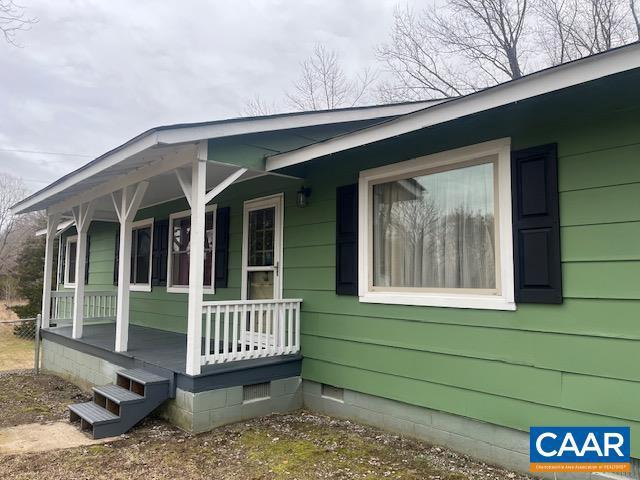 view of property exterior featuring crawl space and a porch