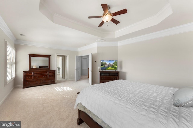 carpeted bedroom with ceiling fan, ornamental molding, and a raised ceiling