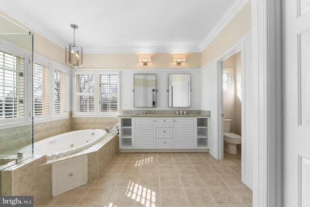 bathroom with tiled tub, ornamental molding, tile patterned flooring, and vanity