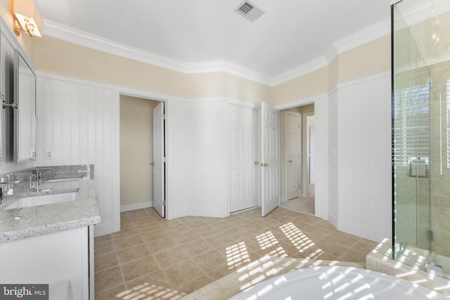 bathroom with vanity, tile patterned flooring, crown molding, and walk in shower