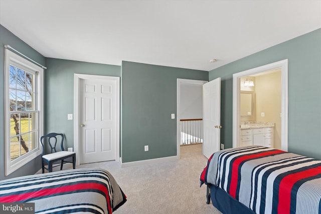 bedroom featuring light carpet and connected bathroom