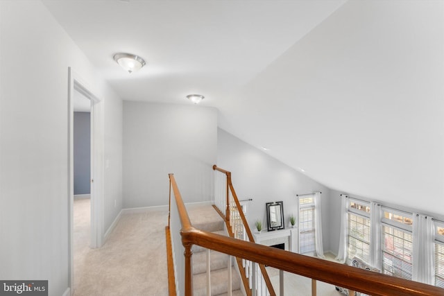 hall with light carpet and lofted ceiling