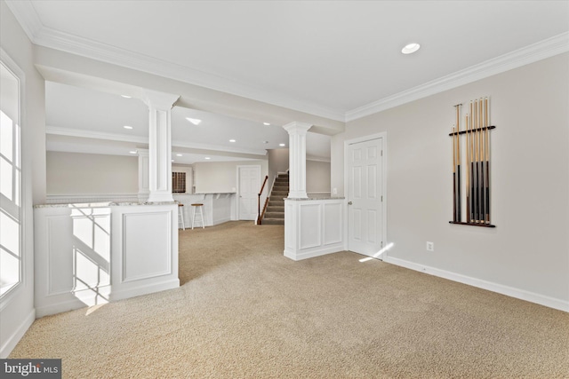 spare room with light carpet, ornamental molding, and ornate columns