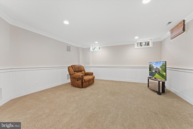 living area with ornamental molding and carpet