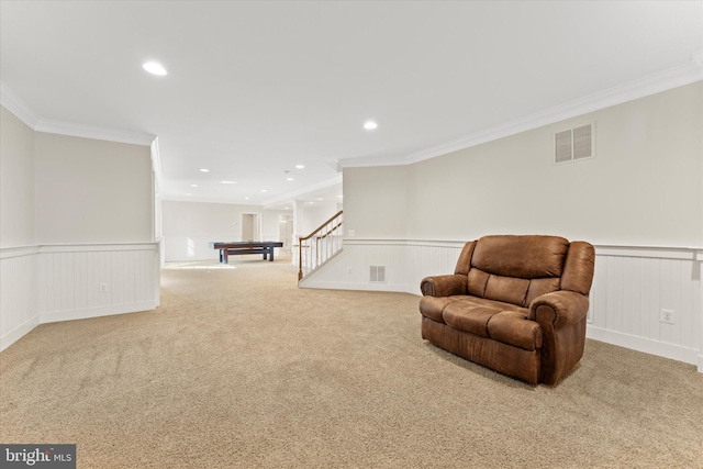 sitting room featuring crown molding and light colored carpet