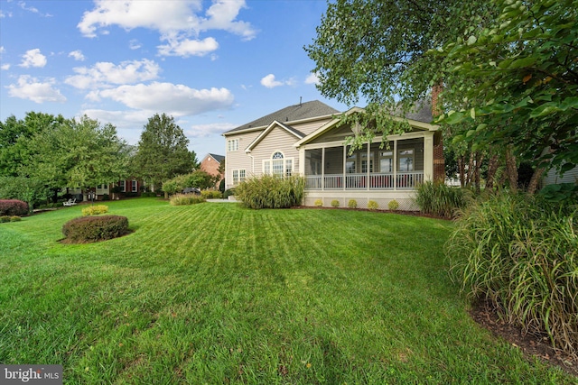 view of yard featuring a sunroom