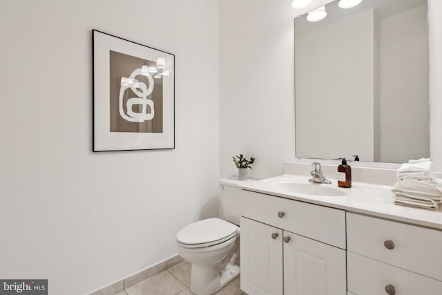 bathroom with vanity, toilet, and tile patterned flooring