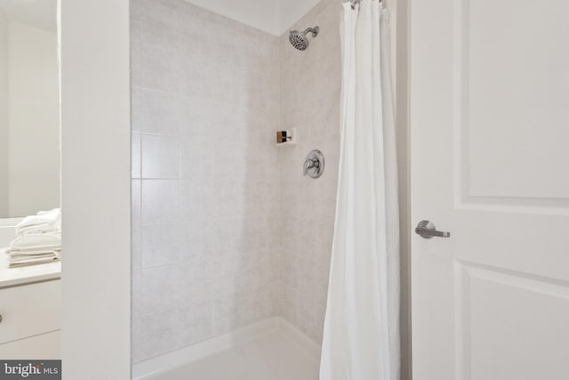 bathroom with walk in shower and vanity