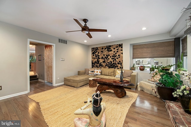 living room with hardwood / wood-style flooring and ceiling fan