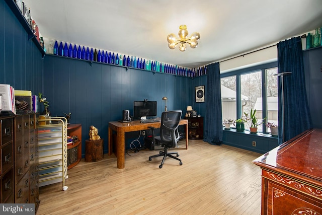 office with hardwood / wood-style flooring and a chandelier