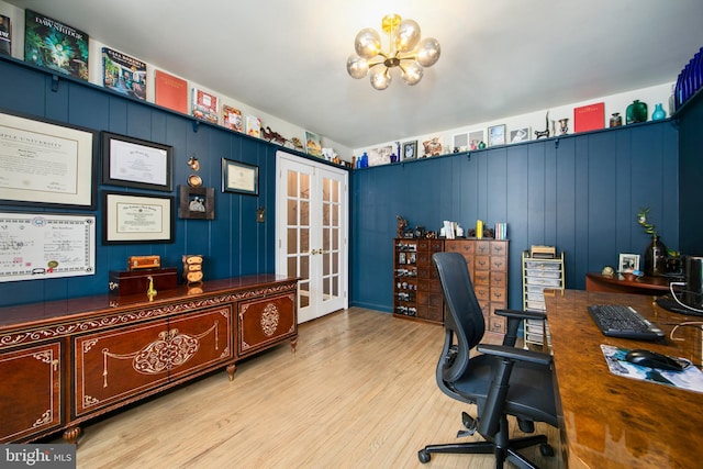 office space featuring french doors, a chandelier, and light wood-type flooring