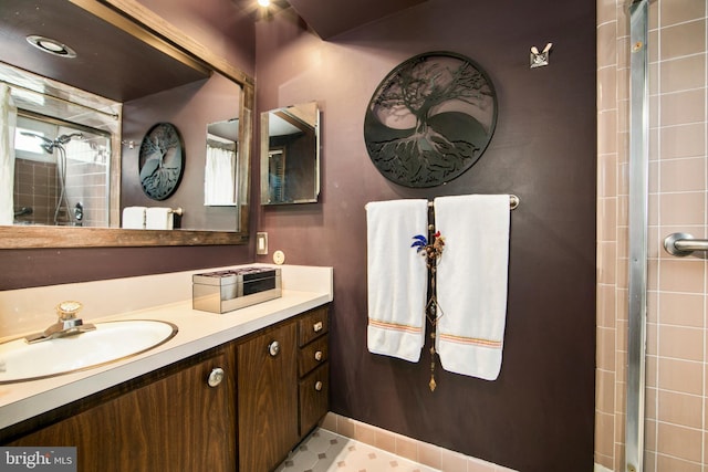 bathroom featuring vanity and a tile shower