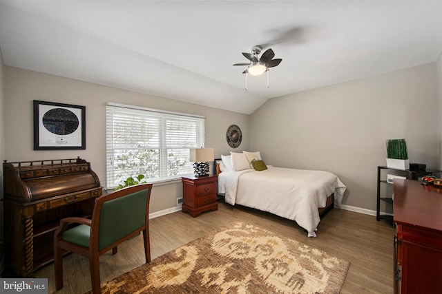 bedroom featuring ceiling fan, lofted ceiling, and light wood-type flooring