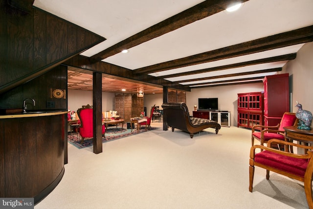 interior space featuring light colored carpet and beamed ceiling