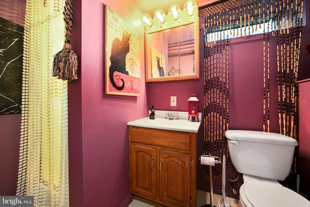 bathroom featuring vanity and toilet