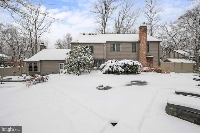 view of snow covered rear of property