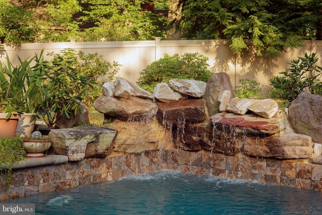 exterior space featuring pool water feature