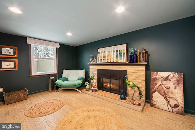 sitting room with hardwood / wood-style floors and a fireplace