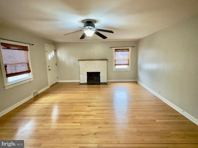 unfurnished living room featuring ceiling fan and light hardwood / wood-style flooring