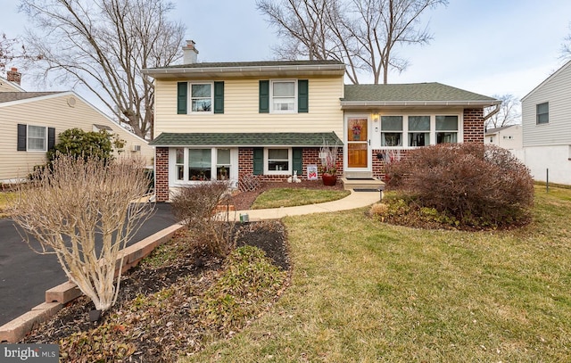 tri-level home featuring a front yard