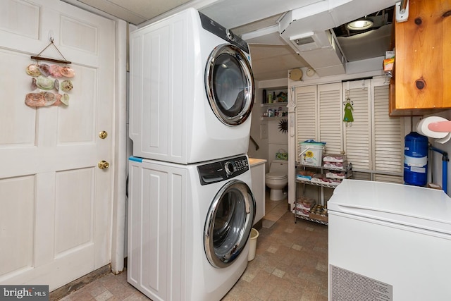 laundry area featuring stacked washing maching and dryer