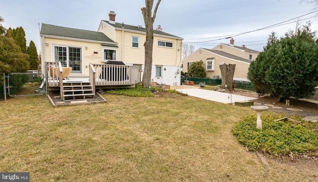 back of property featuring a yard and a deck