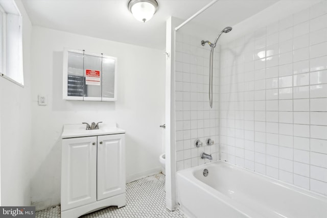 full bathroom featuring vanity, toilet, tiled shower / bath combo, and tile patterned flooring